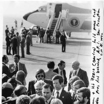 Governor Brown and Vic Fazio talking to folks at press conference at airport; Senator Cranston at rear. Air Force One in background. "Gov. Brown & Vic Fazio (center) hold press conference after President has boarded A.F.1