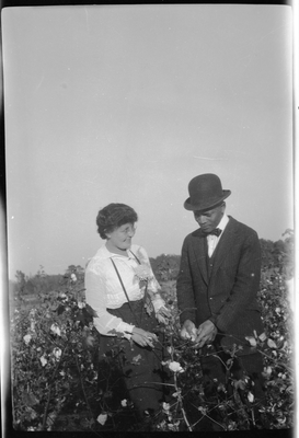 Pearl Hinds Roberts and man standing in cotton field