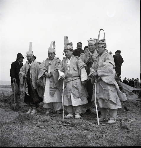 Men in traditional grieving attire during a Korean funeral
