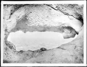 View of desert seen through a hole in cliff, near Phoenix, Arizona, ca.1900-1930
