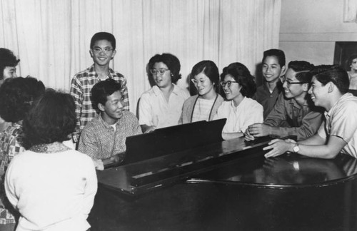 Youth gathered around piano