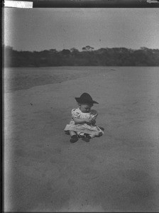 Child on a river bank, Mozambique, ca. 1901-1907