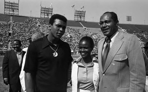 Muhammad Ali, Cicely Tyson, and Tom Bradley posing together at the Freedom Football Classic, Los Angeles, 1973