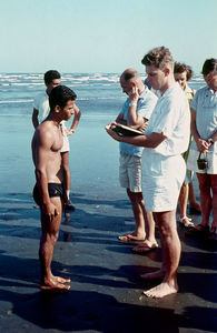 Rev. Verner Tranholm-Mikkelsen is baptising Abdul Malik on the Beach in Ma'alla, Aden
