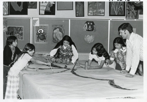 Student teacher leading art project, mid 1970s