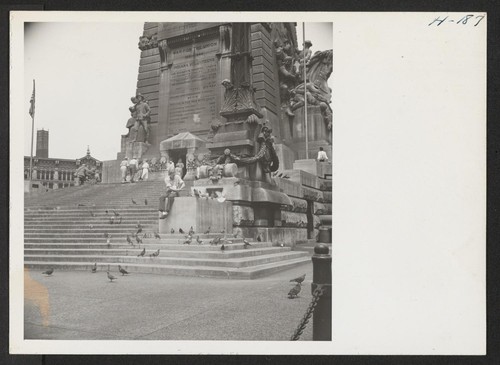 A scene at the base of the colossal Soldiers and Sailors Monument in The Center in the heart of the Indianapolis business district. Photographer: Mace, Charles E. Indianapolis, Indiana