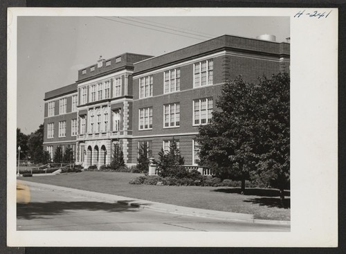 High School in Lawrence, Kansas. This building is typical of high school buildings throughout the middle west. Photographer: Mace, Charles E. Lawrence, Kansas
