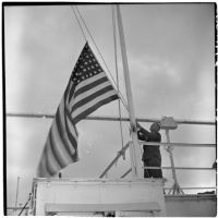 Tony Cornero raising the U.S. flag on his newly refurbished gambling ship, the Bunker Hill or Lux, Los Angeles, 1946