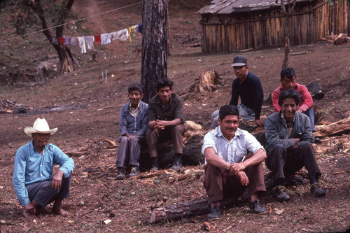 Guatemalan refugees sitting on logs, Santiago el Vértice, ca. 1983
