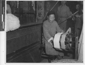 A Chinese woman prepares thread at Wuzhou, China, 1946