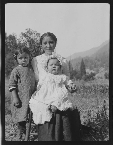 Native American woman with girl and baby