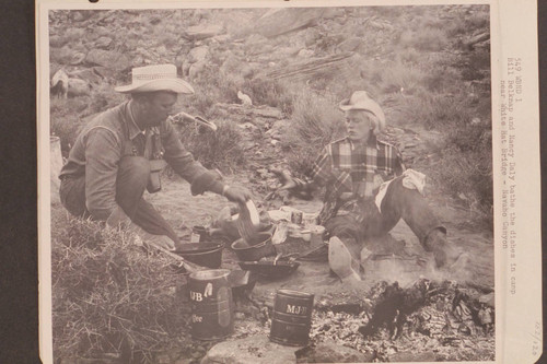 Bill Belknap and Nancy Daly bathe the dishes in camp near White Hat Bridge; Navajo Canyon