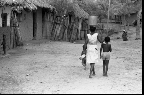 Woman and child walking in the street, San Basilio de Palenque, 1975