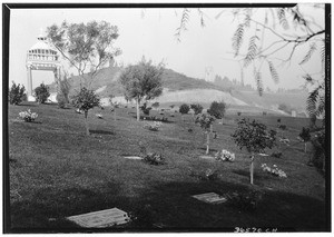 View of Forest Lawn cemetery grounds, showing a sepulchral monument in the background, November 1929