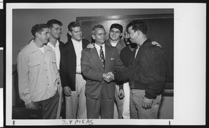 University of Southern California head football coach Jess Hill being congratulated by the football team on his appointment as head coach, USC campus, January 1951