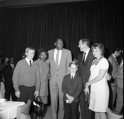 Tom Bradley posing with a group during his mayoral campaign, Los Angeles, 1969