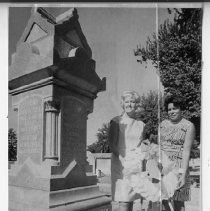 Mrs. Fred Heitfeld, left, and Mrs. Eddie Brown, members of the Ann Land and Bertha Henschel Memorial Fund Commission, placed a wrath at the tomb of Miss Henschel in the Sacramento City Cemetery