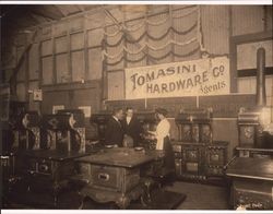 A. F. Tomasini with an unidentified man and woman standing amongst a display of stoves and ranges at A. F. Tomasini Hardware in Petaluma, California about 1895