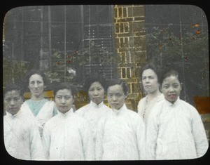 Two adult women standing with younger schoolgirls, Hunan, China, ca.1917-1923