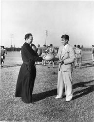 Lorenzo M. Malone, S.J., and Jimmy Cagney in football field