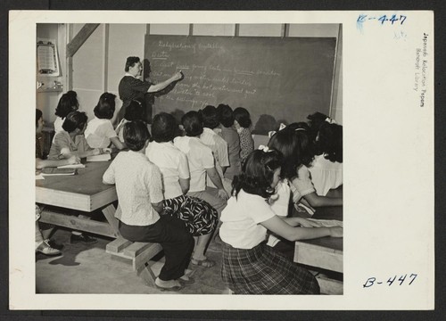 Group picture of a class with the instructor at the blackboard giving lecture on dehydration. Photographer: Stewart, Francis Rivers, Arizona
