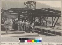 Camp Califorest. After having seen lumber loaded at the sawmill at Spanish Ranch, the class journeyed to the Gray's Flat lumber yard to see the lumber unloaded from the tram and spread out on the sorting table. E.F. July 1931
