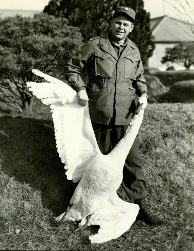 U.S. officer posing with dead swan