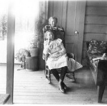 Two girls posing on a porch