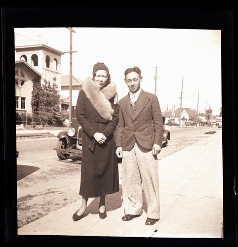 [Fred Louis and woman on sidewalk]