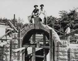 Peter Maroni and August Deghi sit upon an arch during construction of unidentified building (possibly Healdsburg Grammar School) in 1900