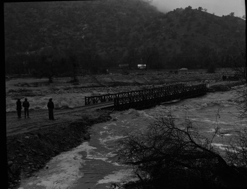 Wayne Alcorn, Middle Fork Kaweah River in Three Rivers (just upriver from site of present Chevron station). Floods and Storm damage. "Bailey Bridge" erected after flood. 560100