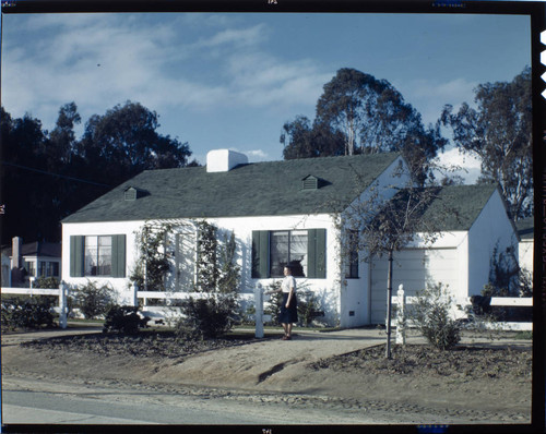 [Unidentified residential exteriors and landscaping]. Woman and exterior