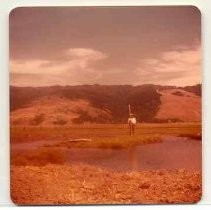 Photographs of landscape of Bolinas Bay. Unidentified person standing on small island in Bolinas Lagoon, possibly holding a survey tool