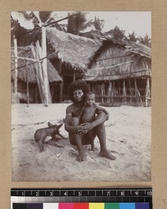 Parent and child sitting on beach, Delena, Papua New Guinea, ca. 1905-1915