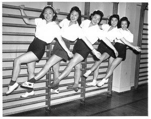 "A group of Japanese girls 'limber up' at gymnasium in the Japanese quarter of Los Angeles. Left to right: Sue Noma, Maye Noma, Lily Takeda, Shigeko Oi, and Meri Taniguchi. All are Nisei."--caption on photograph
