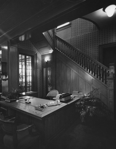 Desk with a name plate for Norma Wickersheim in the Dr. Julius Crane house on 518 N. Broadway after it was converted to Santa Ana First Federal Savings and Loan