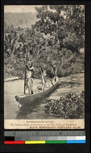 Three young men poling a boat near the shore, Madagascar, ca.1920-1940