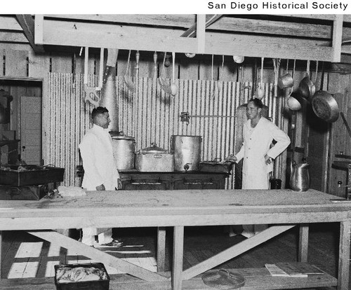 Two soldiers in the kitchen of Camp Derby in Balboa Park during the 1935 Exposition