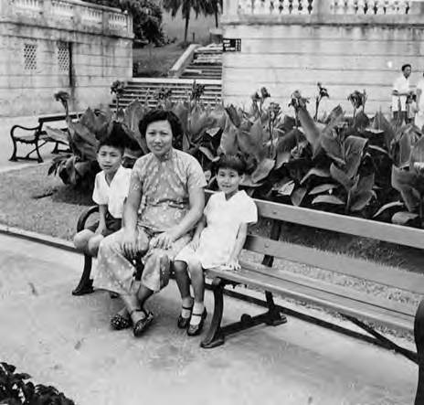 Chai Yip, Henry and Susan Quan seated on a bench in Hong Kong