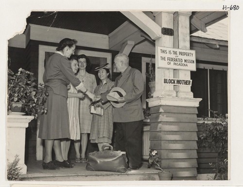 Takejiro Noguchi, Issei from Gila River, being greeted on arrival at the Pasadena Hostel. Shown left to right are: Miss