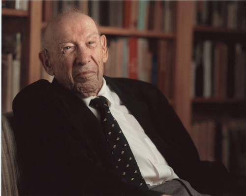 Peter Drucker seated in a chair