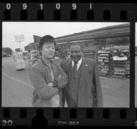 Jin Lee with Reverend Huey Rachal outside Lee's dairy store in Los Angeles, Calif., 1986