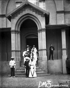 Procession of bridal couples coming out of a chapel, Khovo, Maputo, Mozambique, ca. 1901-1915