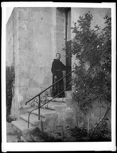Priest entering the side door to the chapel at Mission Santa Barbara, 1898