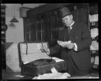 Detective or attorney examining contents of suitcase, possibly evidence in Fay Sudow murder case, [1920?]