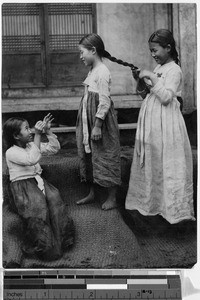 Girl braiding hair, Korea, ca. 1920-1940