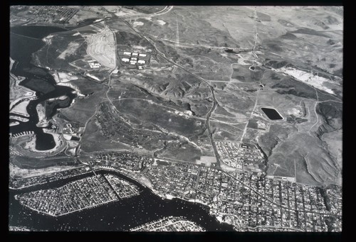 Aerial view of Newport Beach and future campus site in Irvine, ca. 1958