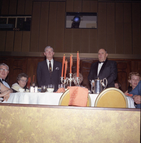 Fritz Huntsinger and unidentified man standing for recognition at Pepperdine's Birth of a College dinner, 1970