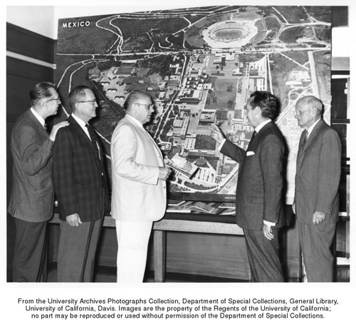 Islas, Antonio, Mexican Consul in Sacramento, presents this 9' x 6' full color photo-mural of the University of Mexico campus to officials of the U.C. Davis campus, in appreciation for the University of California's aid to the agriculture of Mexico. Senor Islas bestowed the gift on behalf of Luis E. Bracamontes, Under Secretary of Public Works, and the entire Department of Public Works of the Republic of Mexico. Richard L. Nelson, Professor of Art and Chairman of the Department of Art, Harry R. Laidlaw Jr., Professor of Entomology and Associate Dean of the Davis College of Agriculture, Davis chancellor Emil M. Mrak; and Fred S. Wyatt, special assistant to the Chancellor (left to right)