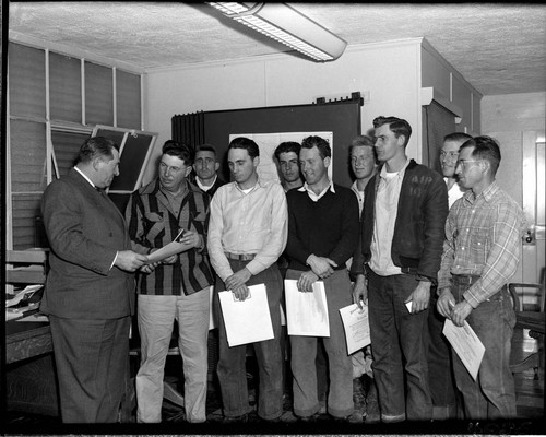 Nine men receiving certificates from Edison Electric Institute
